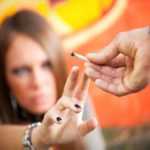 cropped view of two young adults smoking a joint
